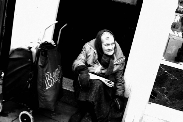 Bag lady resting on a door step, Spitalfields 1986
