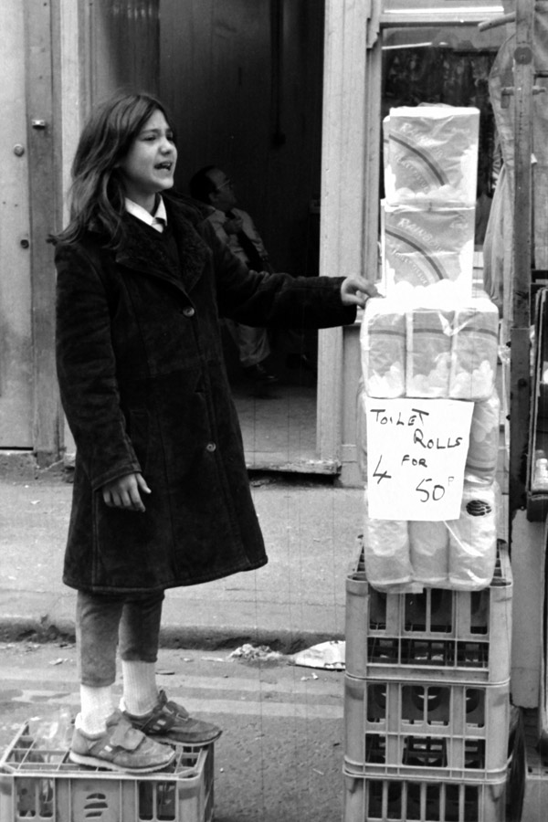 Girl selling toilet rolls in Cheshire Street, 1984