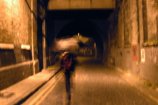 Hazuan approaches Fleet Street Hill bridge at night, 2003