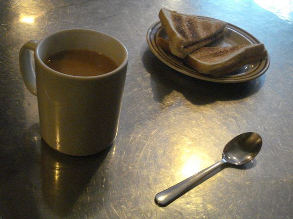 Tea, solar pulses, teaspoon and toast at Rossi's. Hanbury Street, London 2009.