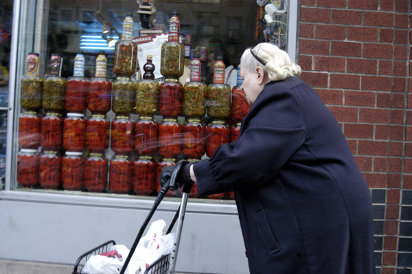 Lady pushing shopping trolley. New York, 2005.