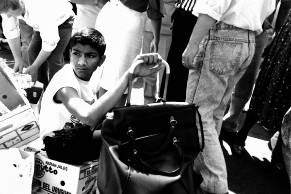 Boy with a shopping trolley. Brick Lane market. London 1984