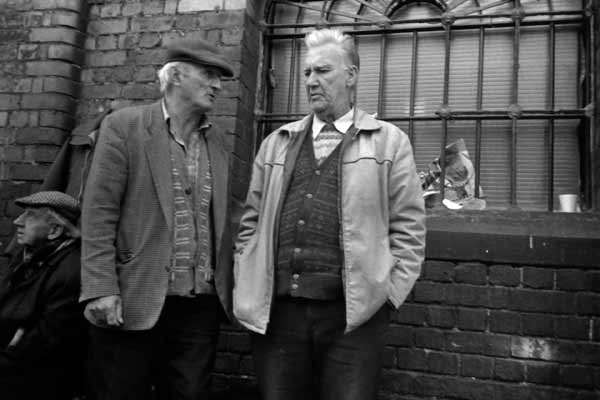 Two men converse. Bishopsgate Goods Yard. London 1998