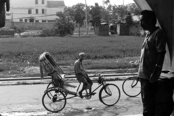 Rickshaw driver waiting for a passenger. Dhaka, Bangladesh c.1991