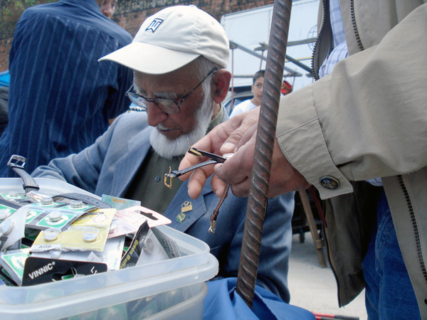 Man selling watches, Sclater street market, London c.2009