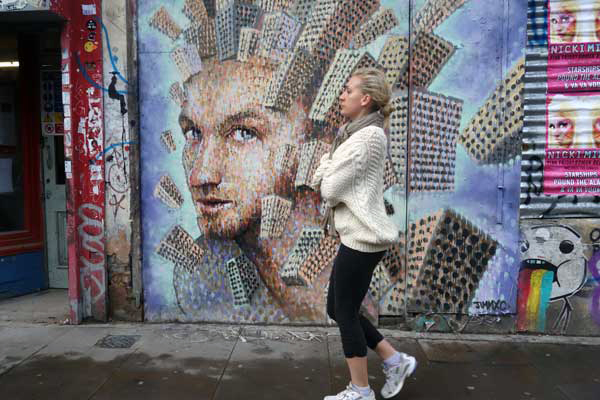 Wall portrait with pedestrian, off Brick Lane 2012