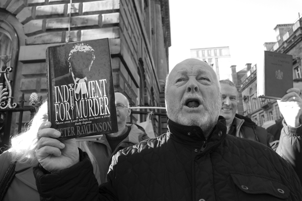 A protester with a library book. Liverpool 2017.