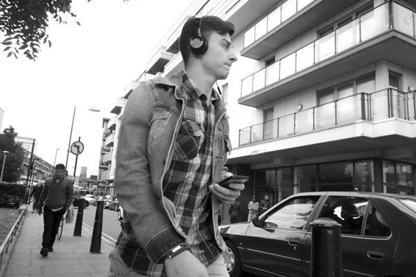 Young man with headphones. Near Watney Market. East London 2017.