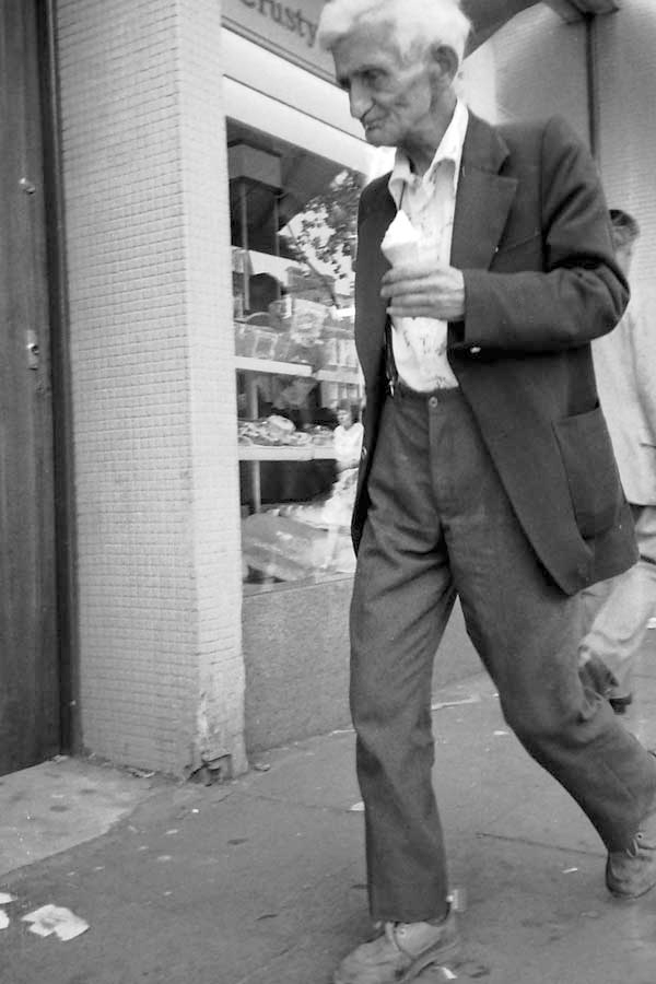 Man with an ice cream. Whitechapel market 1986.