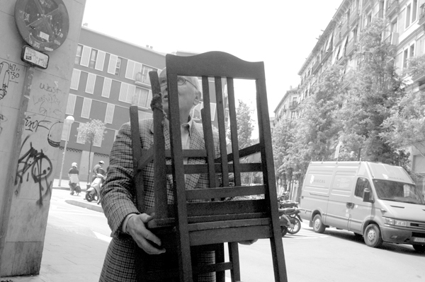 Man carrying chairs. Barcelona 2015.