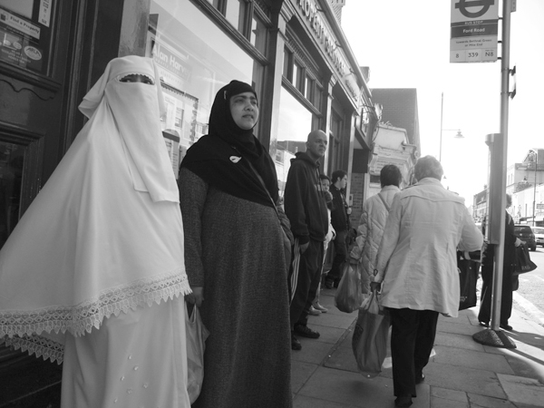 Waiting for a bus. Roman Road, East London 2010. 