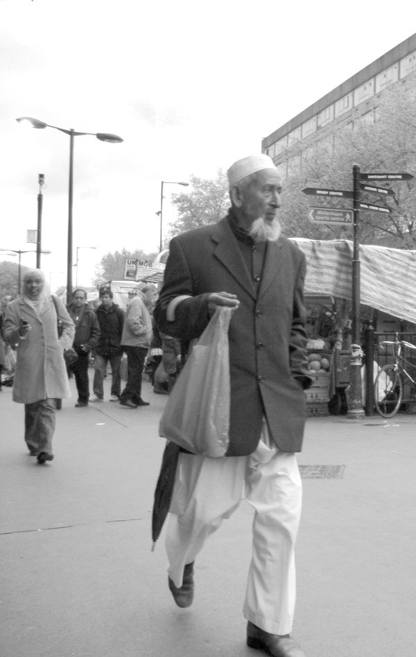 Man with an umbrella. Whitechapel Road. East London, May 2010.