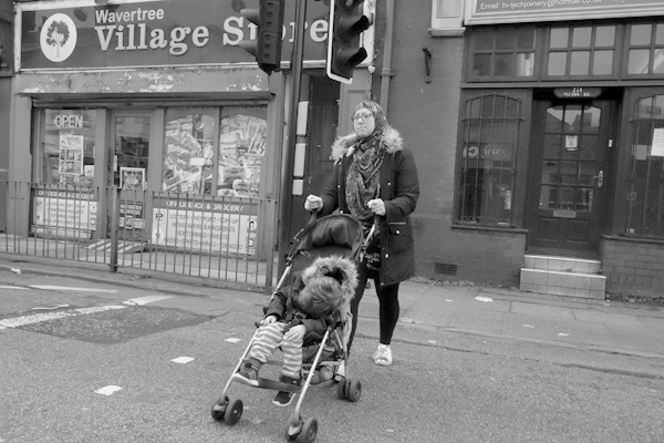 Woman with a pushchair on Picton Road. Liverpool, October 2017. 