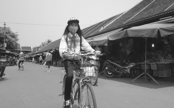 Wearing a mask on a bike. Hoi An, Vietnam 2016.