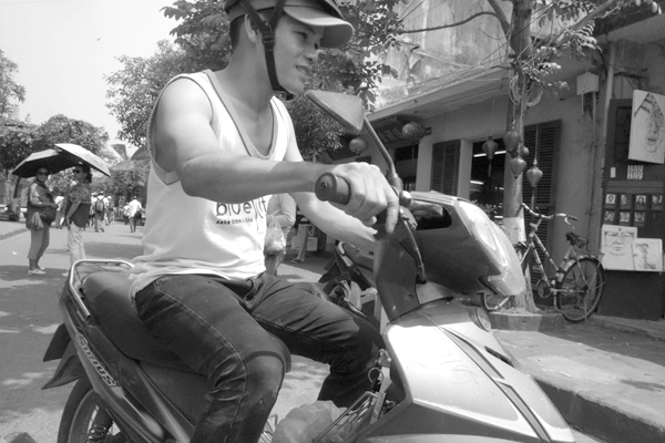 Turning a corner on a bike. Hoi An, Vietnam 2016.
