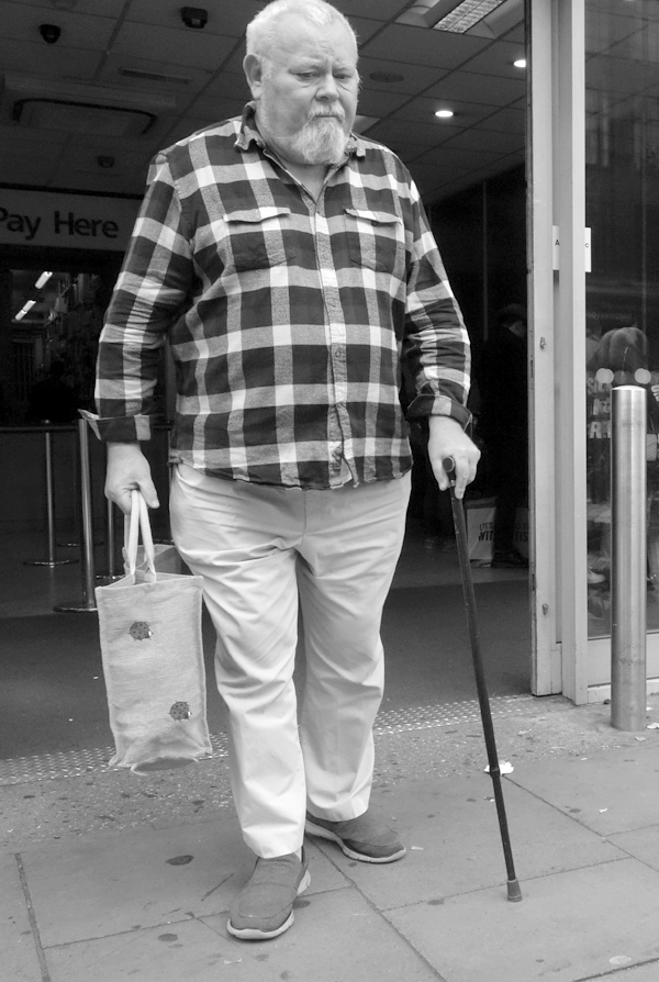 Man with a walking stick in Whitechapel. East London, September 2017.