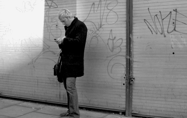 Checking a phone on Brick Lane. East London 2002. 