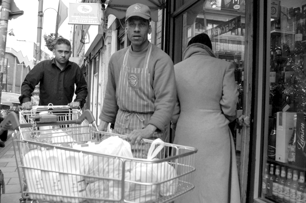 Taj store worker on Brick Lane. East London 2002. 