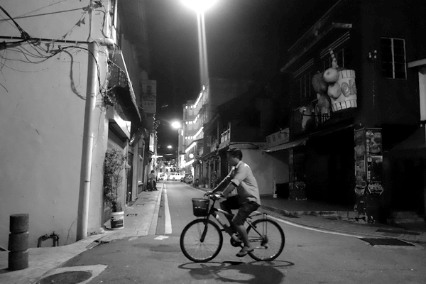 Cycling home at night. Melaka, February 2018.