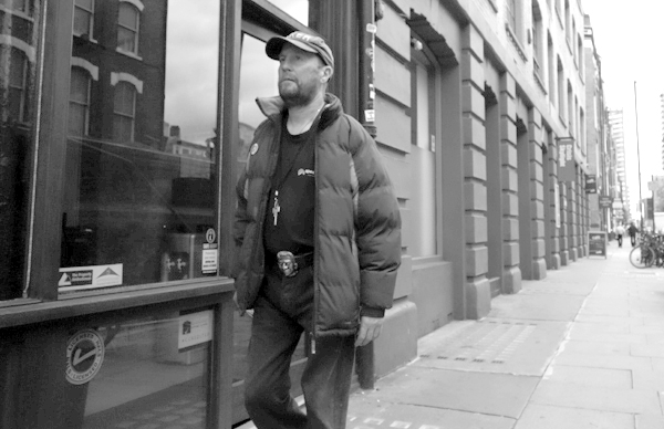 Man wearing a cap on Commercial Street. East London 2016.