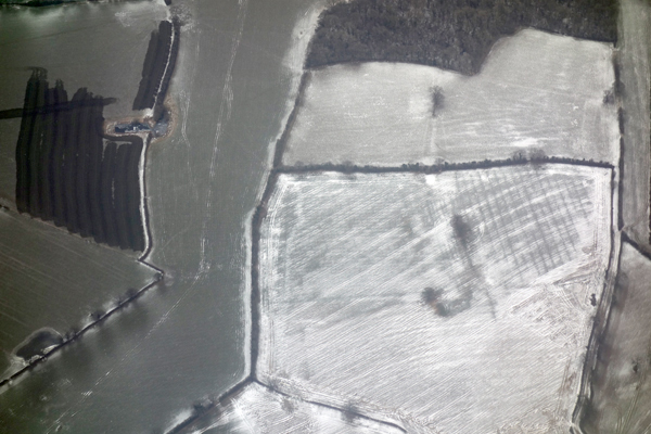 Graphic view of fields and snow during descent into Manchester airport. March 2018.