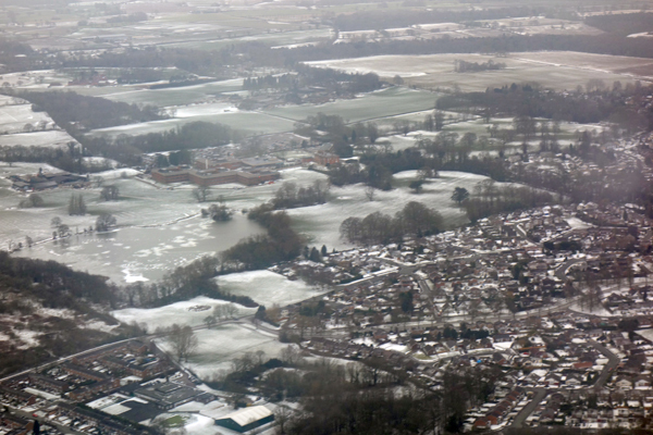 Descent into Manchester airport with a view of housing. March 2018.