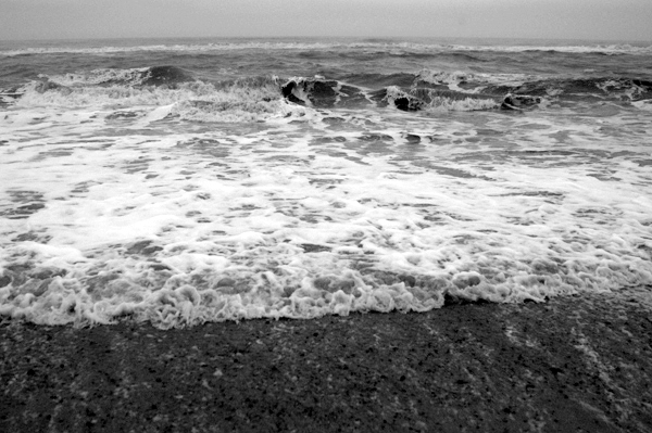 Froth of the stormy sea on the beach. Southwold, December 2002.