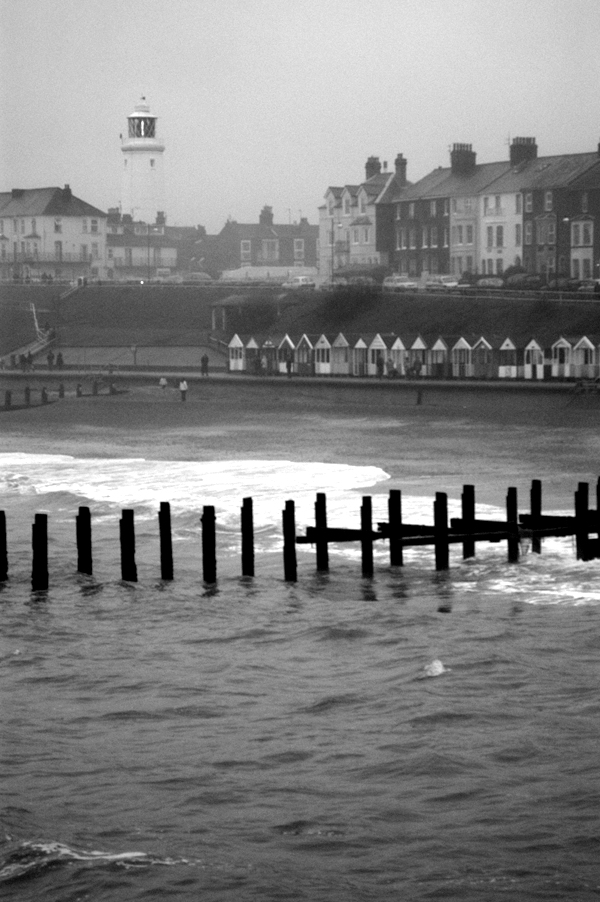 Stormy sea and clouds and the lighthouse viewed from the pier. Southwold, December 2002.