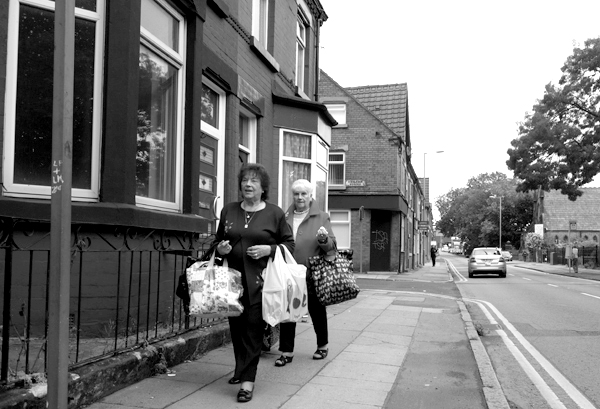 Two women carrying shopping on Wellington Road. Liverpool, September 2019.