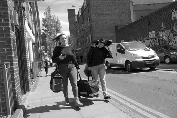 Carrying a bag. Quaker Street. East London 2016.